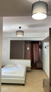 VrysesEmerald Suites的一间卧室配有白色的床和两盏灯