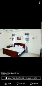 多森Nha Khach Hai Quan的一张卧室的照片,卧室配有一张床和窗帘