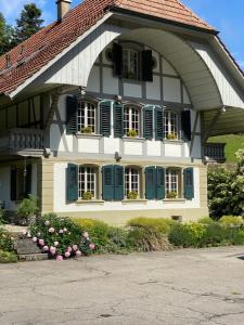 OberburgB&B tannen124的前面有蓝色百叶窗和鲜花的房子