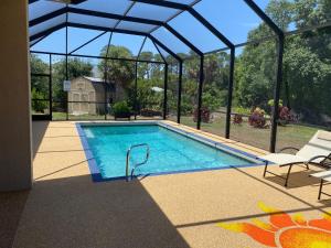 恩格尔伍德Short term vacation rental luxury B&B CTH的一座玻璃屋顶房子中的游泳池