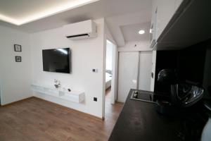 萨拉热窝Luxury Apartments Una Sarajevo的客厅拥有白色的墙壁,墙上配有电视。