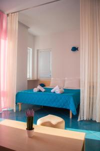 奥赫里德米娜别墅酒店的一间卧室配有一张带蓝色床罩的床