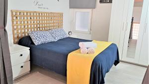 马德里La Vaguada loft的一间卧室配有一张床,上面有两条毛巾