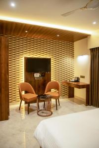 孟买The Majestic Boutique Hotel的酒店客房带一张床、一张桌子和椅子