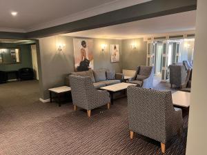 利明顿南草坪酒店 的客厅配有沙发和桌椅