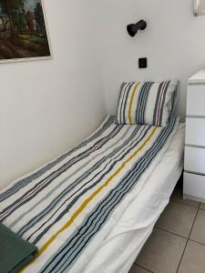 欧尔菲SunShine Apartman的卧室里一张带条纹枕头的床