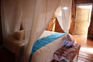 比利亚维哈Infinito Tatacoa的一间卧室配有一张带天蓬的床