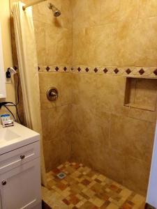 德明BUTTERFIELD STAGE MOTEL的带淋浴的浴室(铺有瓷砖地板)