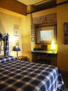 Stazzano拉揣维尔斯纳酒店的一间卧室配有一张床、一张书桌和一个窗户。