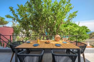 Saint-AntoineProche Monaco, vue mer, accès plage et jardin privatif的庭院里摆放着一张木桌和椅子