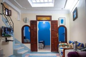 舍夫沙万Chez laasri的客厅设有蓝色的门和沙发