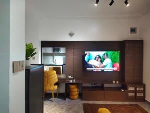 哈科特港Keev Homes & Apartments Shortlet的客厅配有电视、书桌和椅子