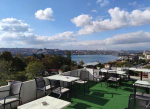 伊斯坦布尔Galata istanbul Hotel的阳台上摆放着一排桌椅,可欣赏到风景