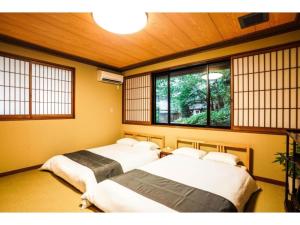 泉佐野Shirakabanoyado Izumi - Vacation STAY 95387v的客房内的2张床,带窗户
