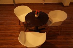 商沙巴5 STAR GRAND- PREMIUM的一张桌子、白色的椅子和花瓶