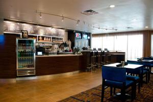 沃特伯里沃特伯里市中心万怡酒店的餐厅设有酒吧,配有桌椅