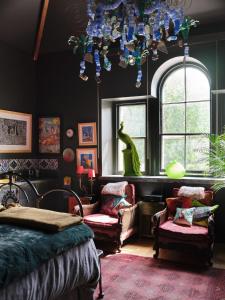 贝图瑟科伊德Alpine Apartments Snowdonia的一间卧室配有一张床、吊灯和椅子