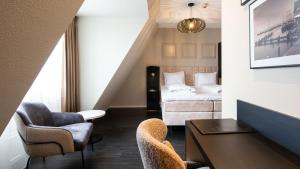 福伦丹Hotel Old Dutch的配有床、椅子和桌子的酒店客房