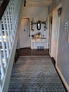塔拉莫尔Coreen Guest House的一条有白色楼梯的走廊,有地毯