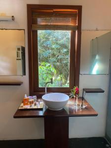 马劳Pousada Bambu Dourado的一个带水槽和窗户的浴室台面