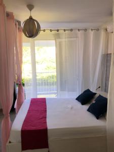 圣皮埃尔夕阳酒店的一间卧室设有一张大床和窗户