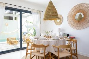 EsteponaEsencia Marbella Casas Boutique的一间配备有白色桌椅的用餐室
