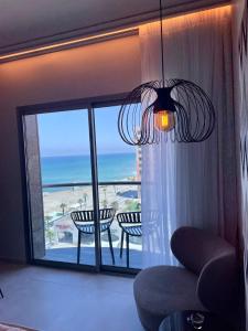 海法Suite on the beach的客厅设有吊灯,享有海景。