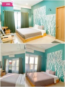 绥和市Joy Hotel Phú Yên的一间卧室设有两张床,拥有蓝色的墙壁。