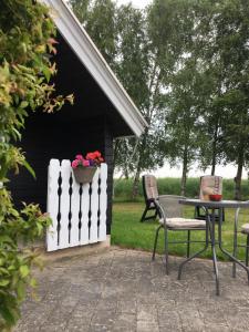 IdestrupStunning Romantic Cabin close to Baltic see的庭院配有桌椅和白色围栏。