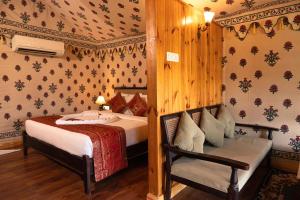 瓦拉纳西Om Vilas Benares的一间卧室配有两张床和椅子