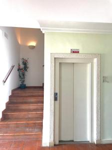 雷焦卡拉布里亚Hotel La Lampara的走廊上设有白色门和楼梯