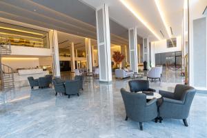 利雅德فندق هوليداي الخليج النجاح的大楼内带桌椅的大堂