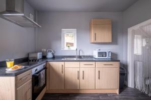BirstallStunning Home Ideal for Business - Free Parking的厨房配有水槽和微波炉