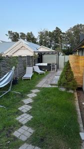 哈尔姆斯塔德Strandviks semesterboende的一个带两把白色椅子和围栏的院子