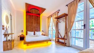 阿拉恰特Banana Alaçatı Wellness Hotel - Adults Only的一间卧室设有一张床和一个大窗户