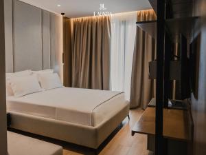 都拉斯La Onda Hotel Durres的酒店客房设有床和窗户。