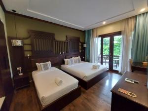 琅勃拉邦Sunrise Garden House - Luang Prabang的酒店客房配有两张床和一张书桌