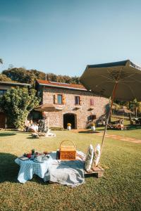 本图贡萨尔维斯Casa Vêneto -Vale dos Vinhedos的一张带篮子和雨伞的野餐桌