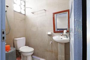北干巴鲁Utama Syariah的一间带卫生间、水槽和镜子的浴室