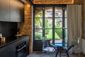 蒙多维Palazzo Fauzone Relais的厨房设有桌子和椅子,毗邻窗户