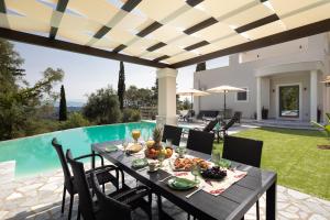 派莱卡斯Villa Tolena的一个带桌椅的庭院和一个游泳池