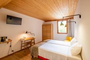 日内瓦La Ferme du Lignon的一间卧室配有一张床、一张书桌和一个窗户。