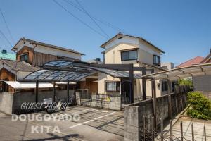 松山GUEST HOUSE DOUGOYADO KITA - Vacation STAY 14923的前面有围栏的房子