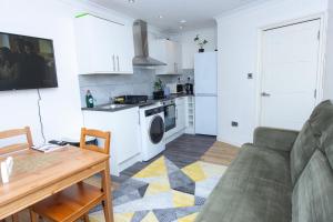 伦敦Evergreen Apartments-Flat 4, London的带沙发的客厅和厨房
