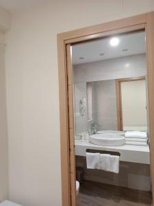 托莱多茵凡特斯旅馆的一间带水槽和镜子的浴室