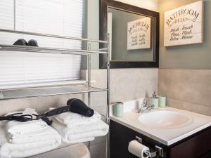 伊丽莎白Stylish & family friendly 3 Bedroom - 8 mins to EWR的浴室配有盥洗盆、镜子和毛巾