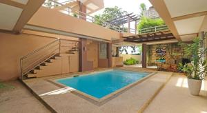 邦劳Villa Tomasa Beach Resort Panglao的房屋中间的游泳池