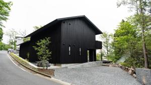 OnsensōMONS GORA - Vacation STAY 68017v的道路边的黑色建筑