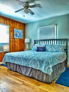 泰比岛Creekside Paradise的一间卧室配有一张床和吊扇