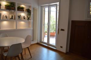 罗马Domi - Appartamento Roma的一间带桌椅和玻璃门的用餐室